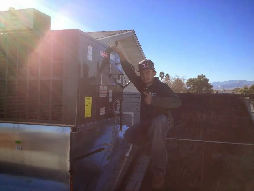 HVAC technician performing AC Tune-Up on a rooftop unit in Upper Merion